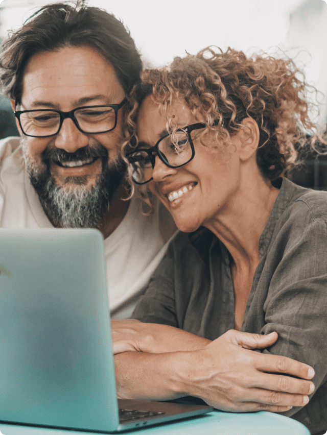 A smiling happy couple applying for a loan